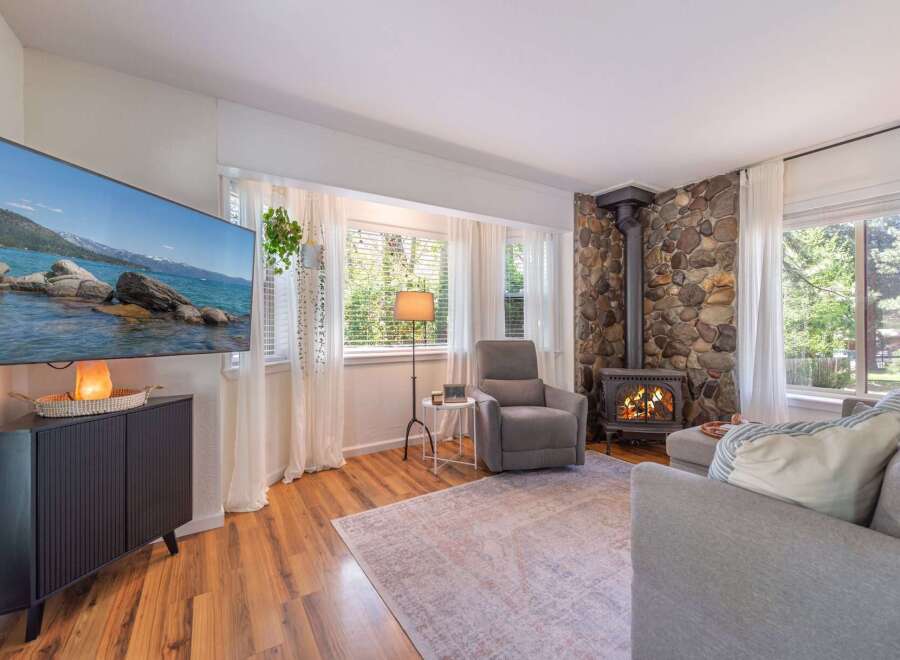 This cozy living room features a stunning stone fireplace, perfect for those chilly evenings.