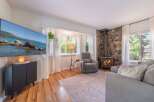 This cozy living room features a stunning stone fireplace, perfect for those chilly evenings.