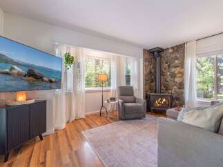 This cozy living room features a stunning stone fireplace, perfect for those chilly evenings.