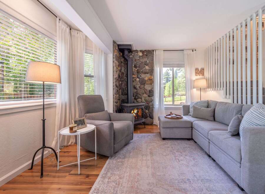 Step into a cozy living space featuring a stunning stone fireplace, perfect for those chilly evenings.