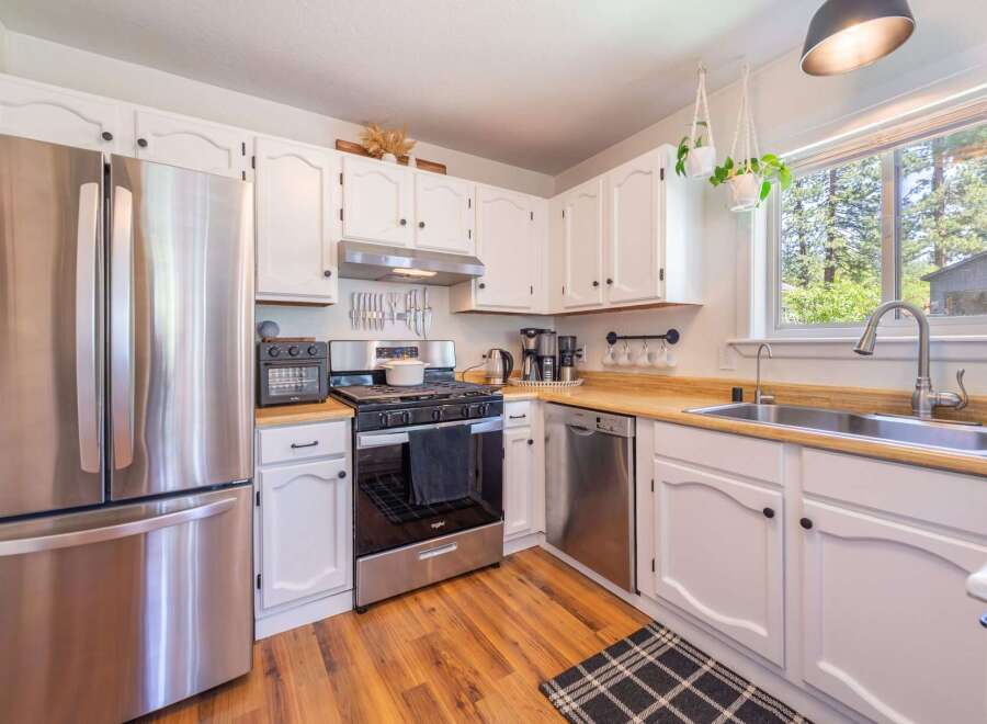 Step into this charming kitchen, featuring stainless steel appliances and ample counter space.