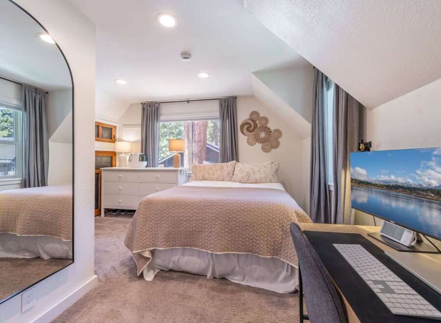This cozy bedroom offers a serene retreat with its inviting ambiance and stylish decor.