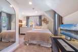 This cozy bedroom offers a serene retreat with its inviting ambiance and stylish decor.
