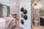 This charming bedroom offers a cozy retreat with its inviting ambiance and stylish decor.