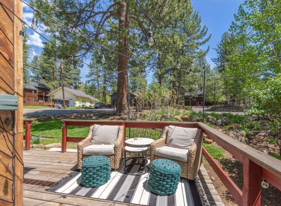 Enjoy the tranquility of this outdoor oasis! This property features a charming deck with comfortable seating, perfect for relaxing or entertaining.