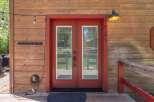 This charming property features a welcoming entrance with a vibrant red door and a classic design.