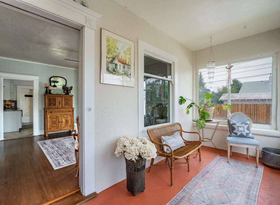 Step into this charming home and discover a sun-drenched porch, perfect for relaxing and enjoying the day.
