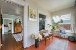 Step into this charming home and discover a sun-drenched porch, perfect for relaxing and enjoying the day.