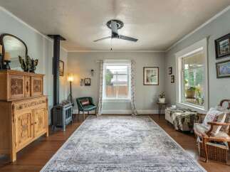 Step into this inviting living space, featuring a cozy ambiance with a vintage-inspired aesthetic.