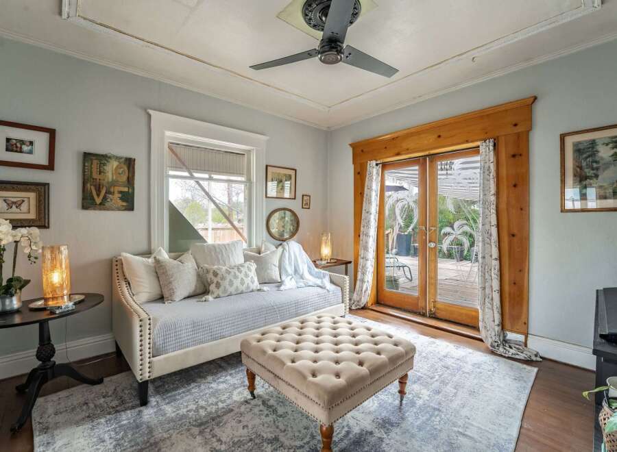 Step into this charming living space, featuring a cozy daybed perfect for relaxation.