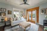 Step into this charming living space, featuring a cozy daybed perfect for relaxation.