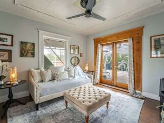 Step into this charming living space, featuring a cozy daybed perfect for relaxation.