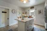 Step into this charming kitchen, featuring a stylish island with ample storage and a beautiful marble countertop.