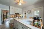 Step into this charming kitchen, featuring a spacious island with a modern cooktop, perfect for culinary creations.