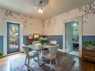 Step into this charming dining room, featuring a unique blend of vintage and modern design.