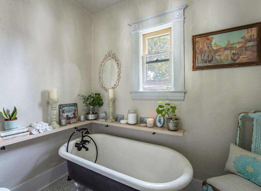 This charming bathroom features a clawfoot tub, creating a vintage and relaxing atmosphere.