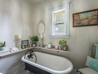 This charming bathroom features a clawfoot tub, creating a vintage and relaxing atmosphere.