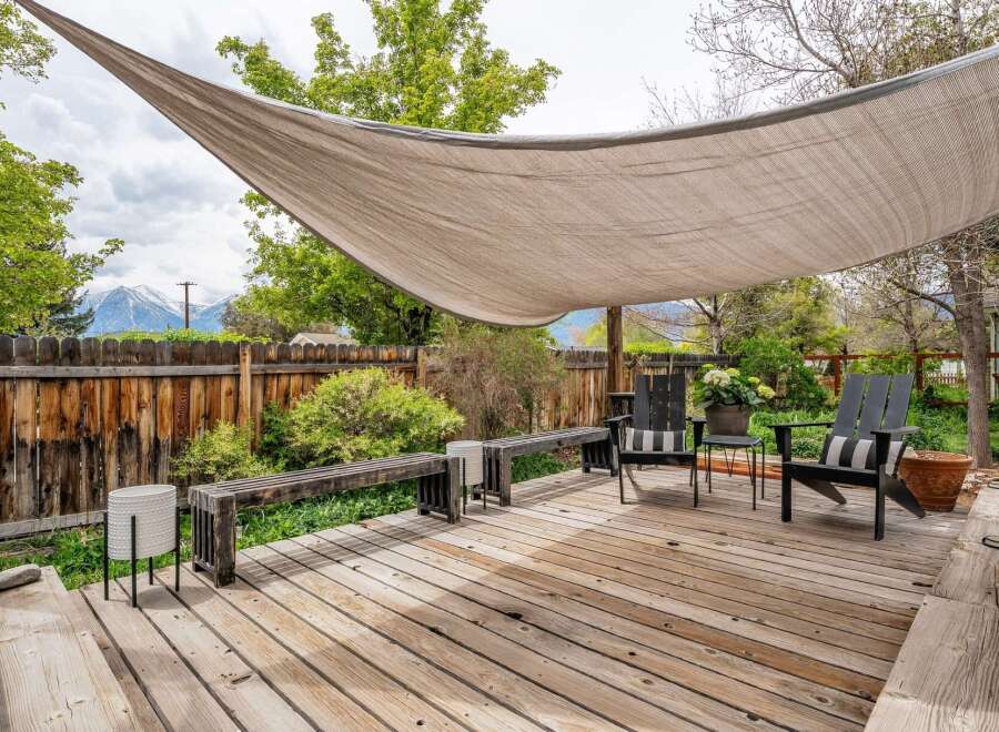 Enjoy outdoor living at its finest with this stunning deck! Featuring a stylish shade sail, comfortable seating, and a beautiful wooden deck, this space is perfect for relaxation and entertaining.