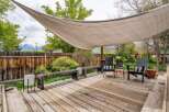 Enjoy outdoor living at its finest with this stunning deck! Featuring a stylish shade sail, comfortable seating, and a beautiful wooden deck, this space is perfect for relaxation and entertaining.