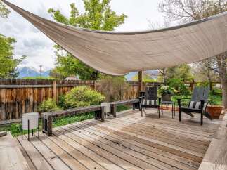 Enjoy outdoor living at its finest with this stunning deck! Featuring a stylish shade sail, comfortable seating, and a beautiful wooden deck, this space is perfect for relaxation and entertaining.
