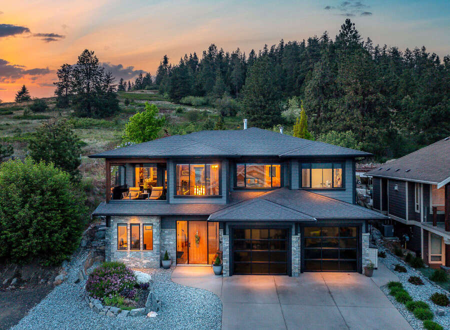 This stunning two-story home boasts a modern design with a beautiful exterior.