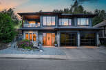 This stunning modern home boasts a sleek design with a beautiful facade.