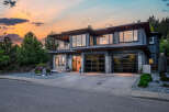 This stunning modern home boasts a sleek design with expansive windows, offering breathtaking views and abundant natural light.