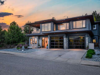 This stunning modern home boasts a sleek design with expansive windows, offering breathtaking views and abundant natural light.