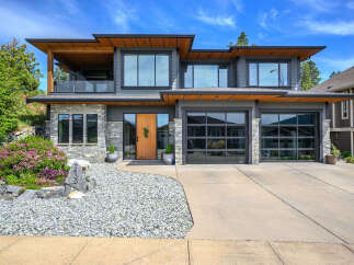 This stunning modern home boasts a sleek design with a beautiful facade.