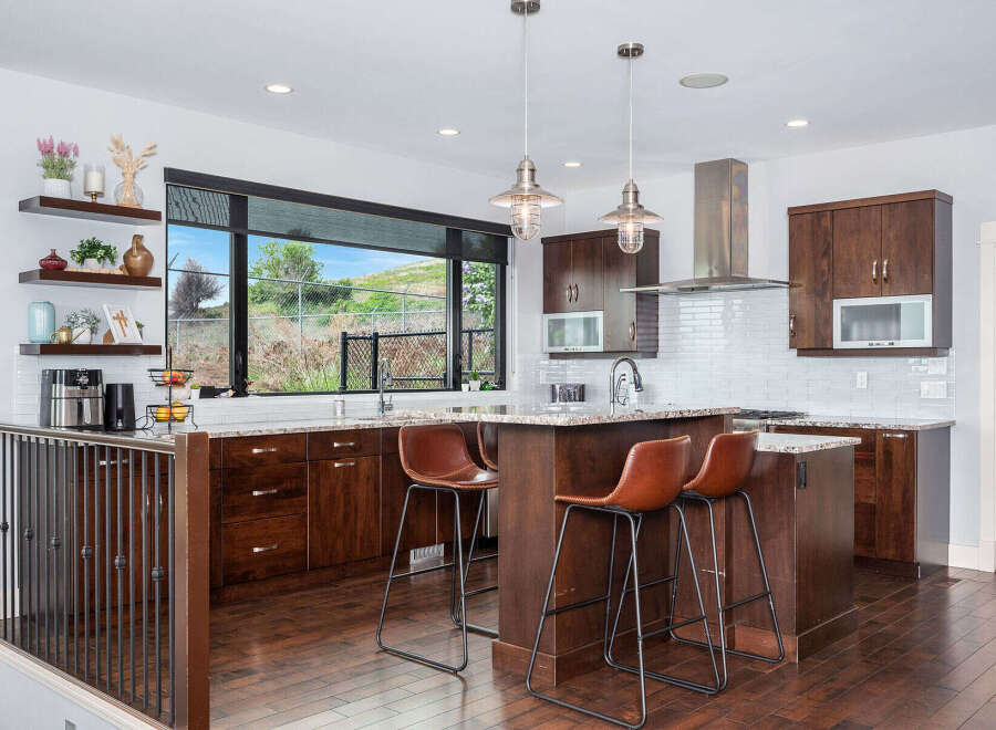 Step into this stunning kitchen, boasting rich wood cabinetry and a spacious island perfect for entertaining.
