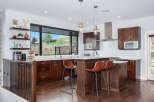 Step into this stunning kitchen, boasting rich wood cabinetry and a spacious island perfect for entertaining.