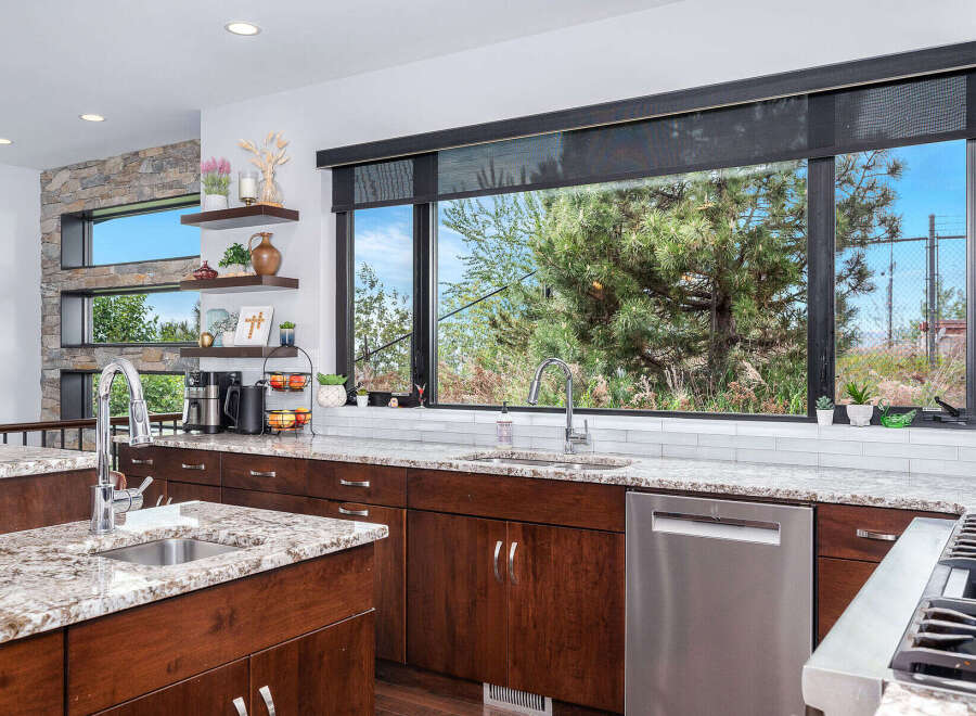 This stunning kitchen boasts a modern design with sleek cabinetry and granite countertops.