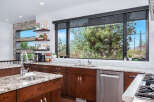 This stunning kitchen boasts a modern design with sleek cabinetry and granite countertops.