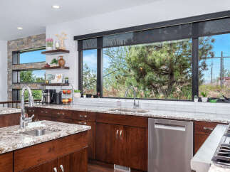 This stunning kitchen boasts a modern design with sleek cabinetry and granite countertops.
