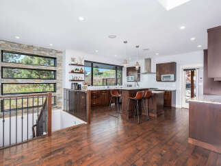 This stunning kitchen boasts a modern design with sleek cabinetry and a spacious island, perfect for entertaining.