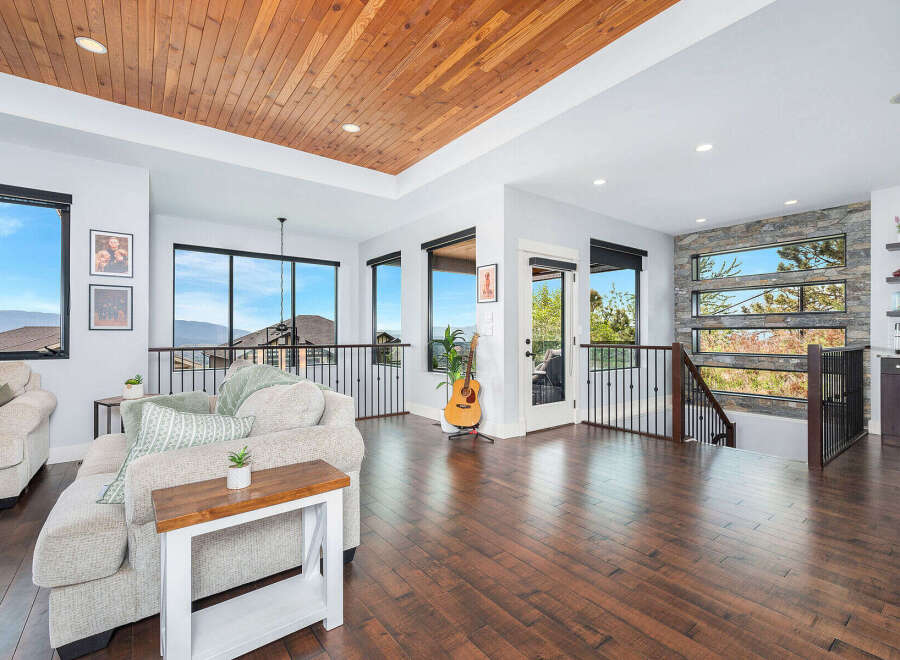 Experience luxury living in this stunning property featuring a warm wooden ceiling and expansive windows that offer breathtaking views.