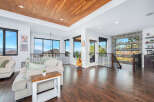 Experience luxury living in this stunning property featuring a warm wooden ceiling and expansive windows that offer breathtaking views.