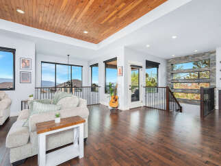 Experience luxury living in this stunning property featuring a warm wooden ceiling and expansive windows that offer breathtaking views.