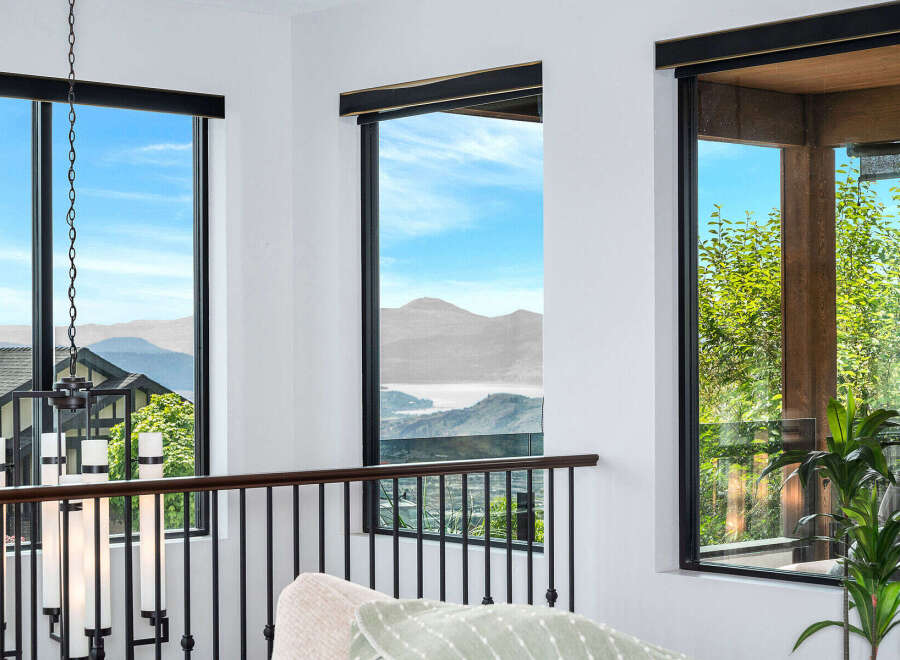 Experience breathtaking views from this stunning property, featuring expansive windows that frame the majestic mountains and serene lake.
