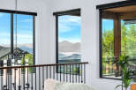 Experience breathtaking views from this stunning property, featuring expansive windows that frame the majestic mountains and serene lake.