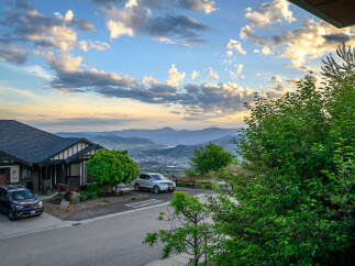 This stunning property offers breathtaking views of the surrounding mountains and valley.