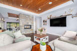 Step into luxury with this stunning living room, featuring a cozy fireplace and a modern entertainment setup.