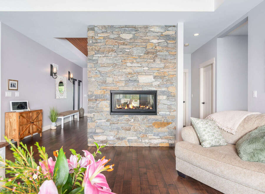 This stunning property boasts a beautiful stone fireplace, creating a warm and inviting atmosphere.