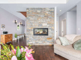 This stunning property boasts a beautiful stone fireplace, creating a warm and inviting atmosphere.