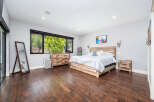Step into this stunning bedroom featuring a rustic wooden bed frame and matching nightstand.
