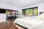 This stunning bedroom boasts a seamless blend of indoor and outdoor living.