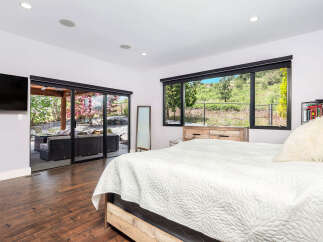 This stunning bedroom boasts a seamless blend of indoor and outdoor living.