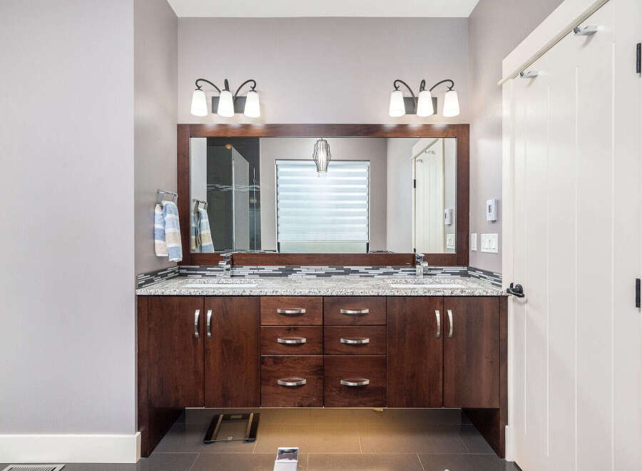 This stunning bathroom boasts a modern design with a double vanity, perfect for shared spaces.