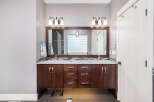 This stunning bathroom boasts a modern design with a double vanity, perfect for shared spaces.