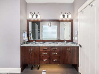 This stunning bathroom boasts a modern design with a double vanity, perfect for shared spaces.